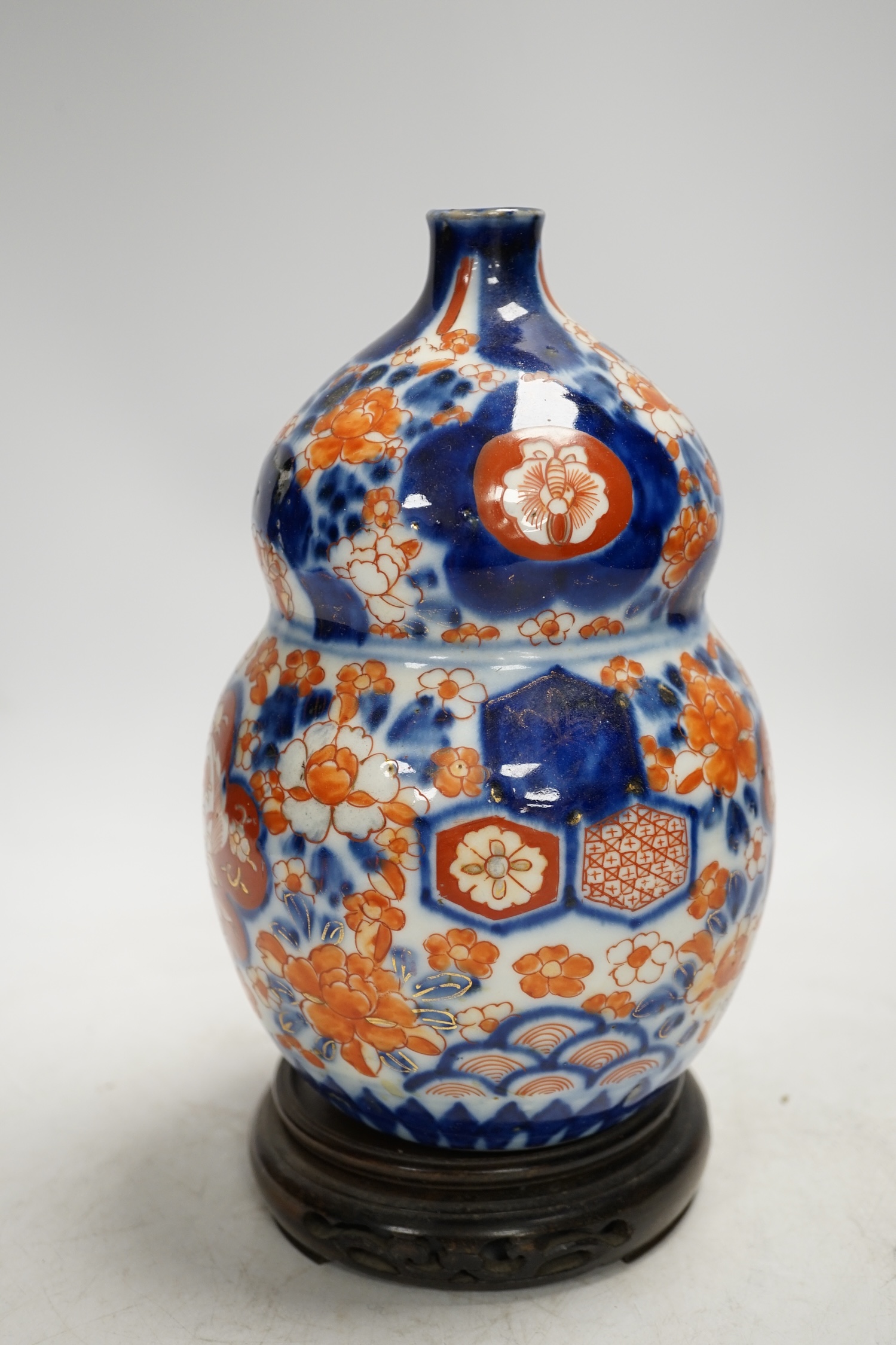 A Japanese Imari double gourd flask on stand, 23cm high. Condition - gilding worn otherwise good